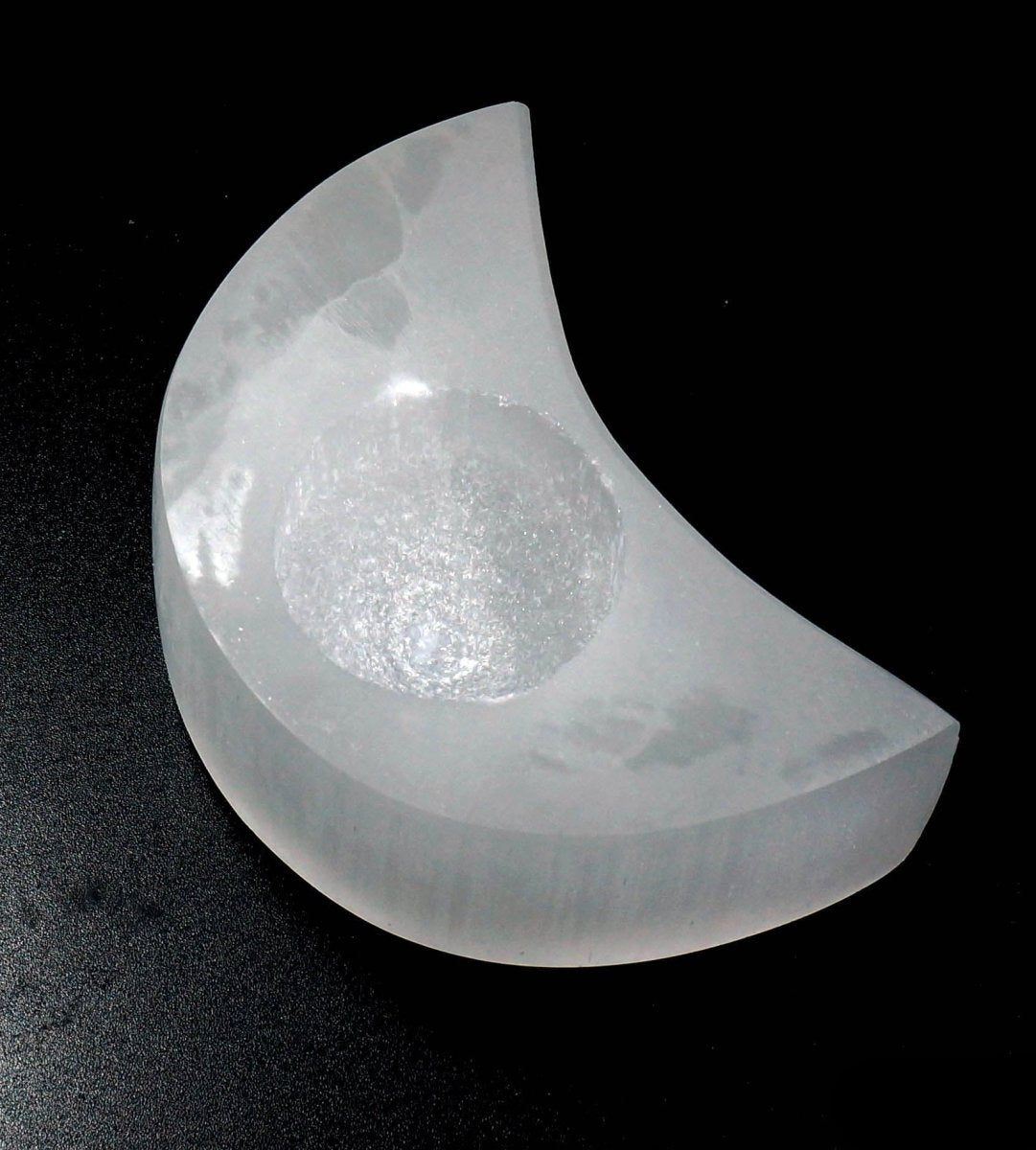 Selenite Moon Tealight on a black background.