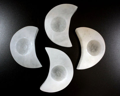 Four Selenite Moon Tealight on a black background.