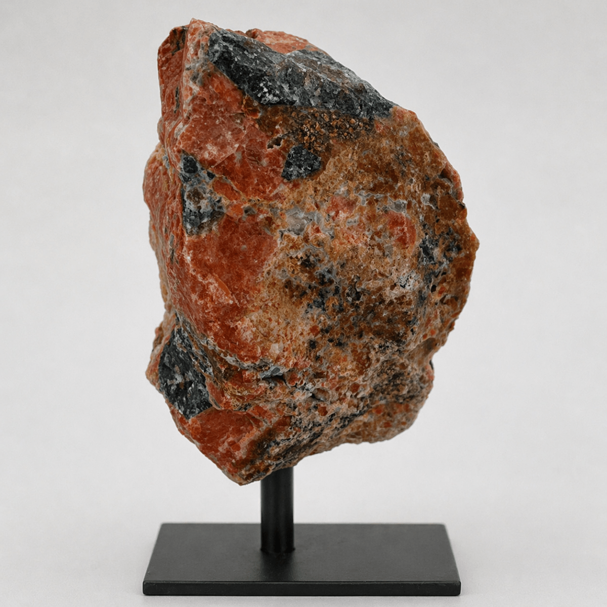 Rough apatite on calcite matrix close-up showing teal-green crystal clusters side view. 